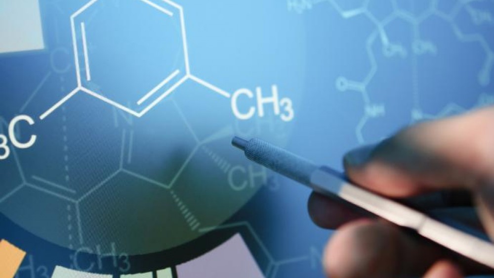 A hand with a pointer pointing to the structural formula of a molecule.