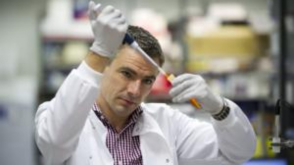 Dr Mike Emerson injecting fluid into a sample tube 