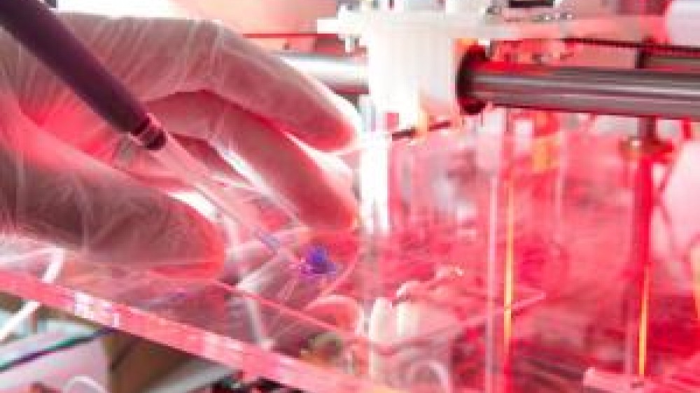 A laboratory technician working with a syringe 