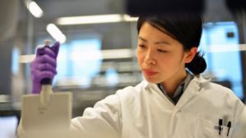 A laboratory technician working with a device