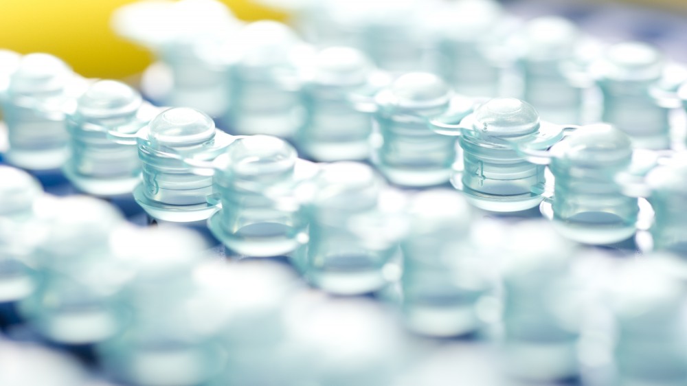 Rows of PCR tubes on a yellow background