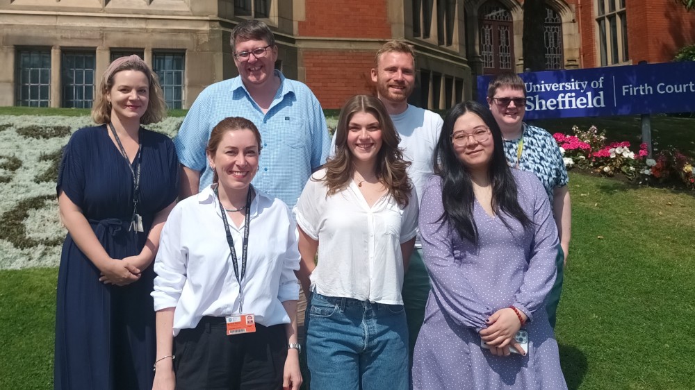 Professor Andrew Peden standing with his research group