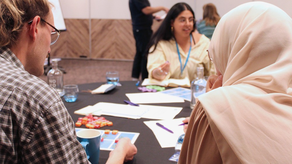 Young scientists talking and working at a table