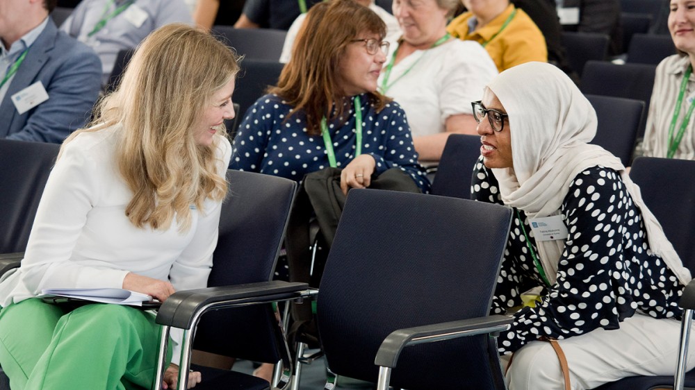 Delegates in discussion at a scientific meeting.