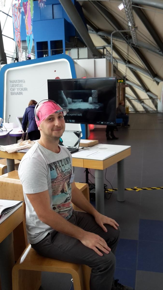 An attendee sitting down with a swimming cap on as part the learning about the 3Rs: science fun for all ages engagement 