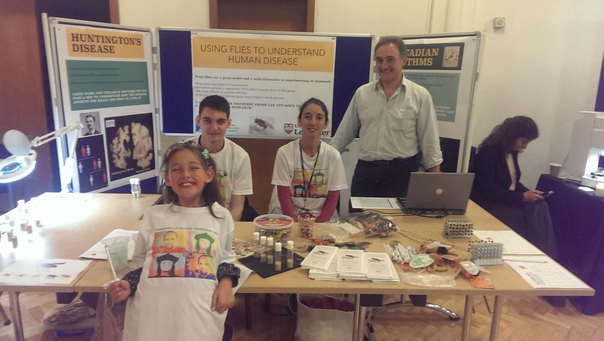 Four attendees at an exhibition stand for the learning about the 3Rs