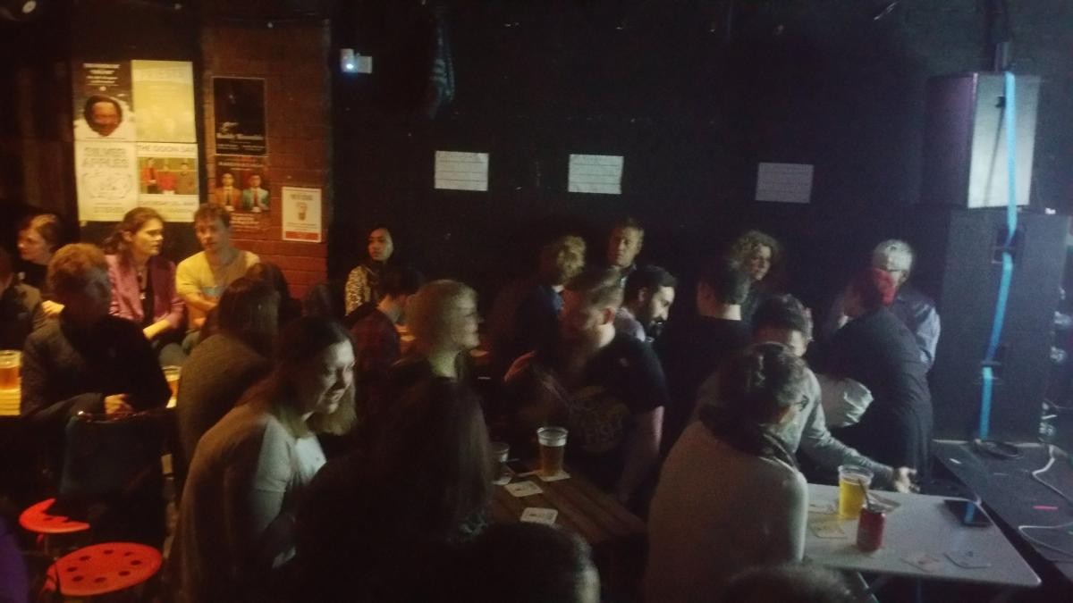 Pint of science event in a Glasgow bar with multiple people sitting down 