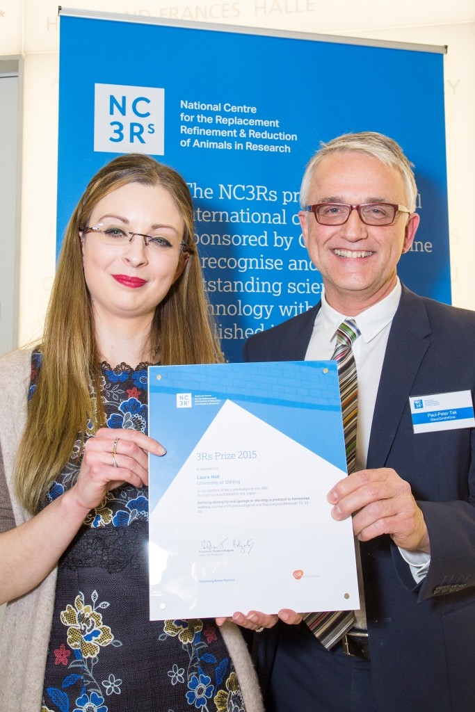 3Rs prize (joint) winner for 2015 Dr Laura hall holding up her certificate with a representative from GSK.