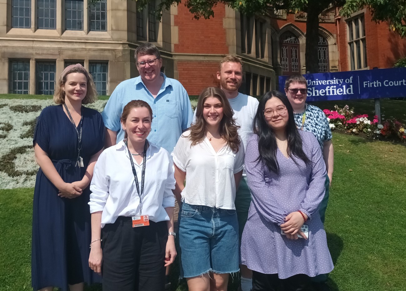 Professor Andrew Peden standing with his research group