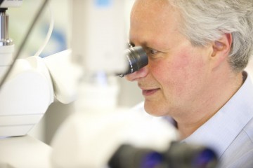 Dr Paul Simons using a microscope